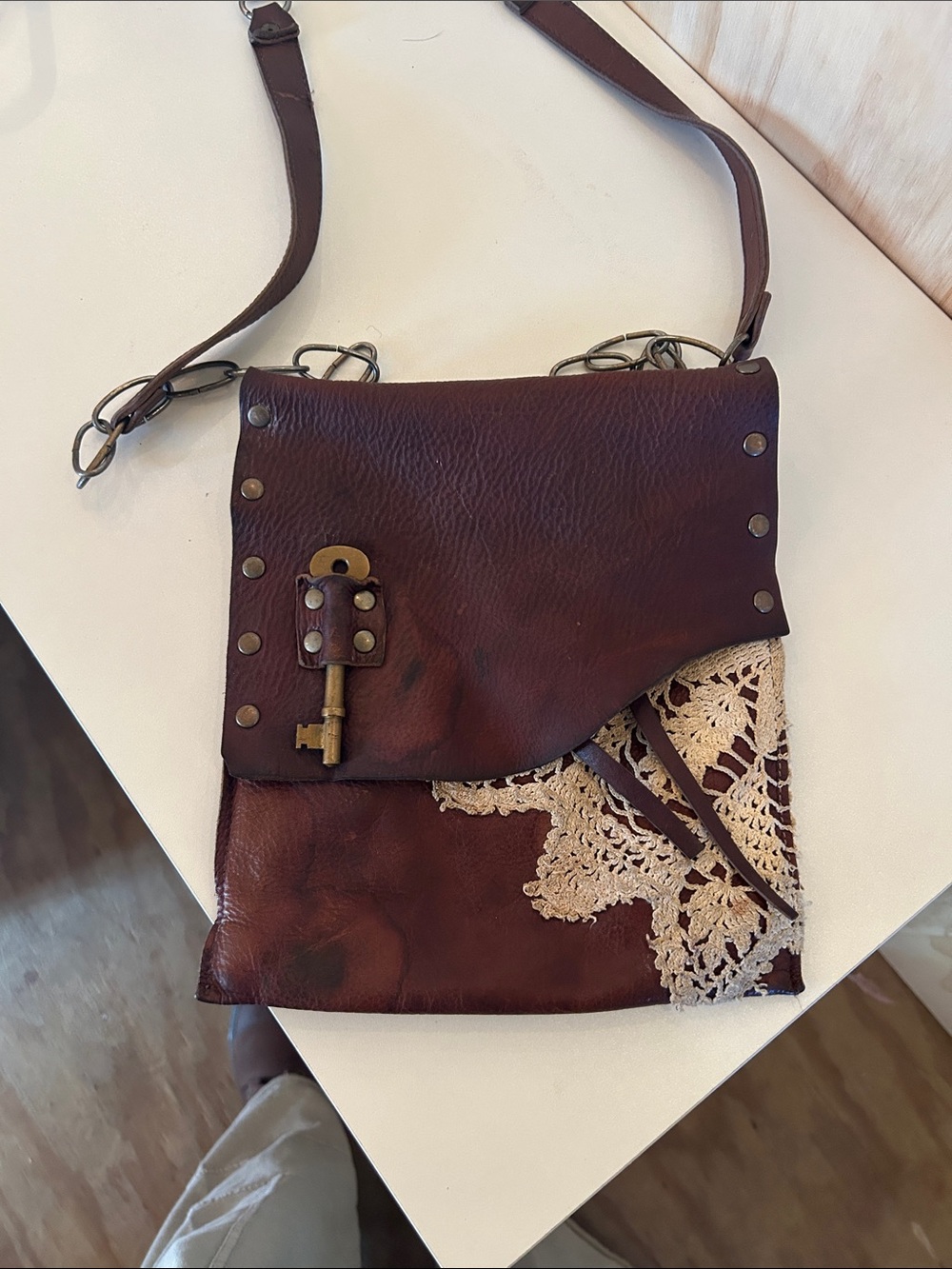 Brown Leather Crossbody Bag with Crochet Accent and Key Charm